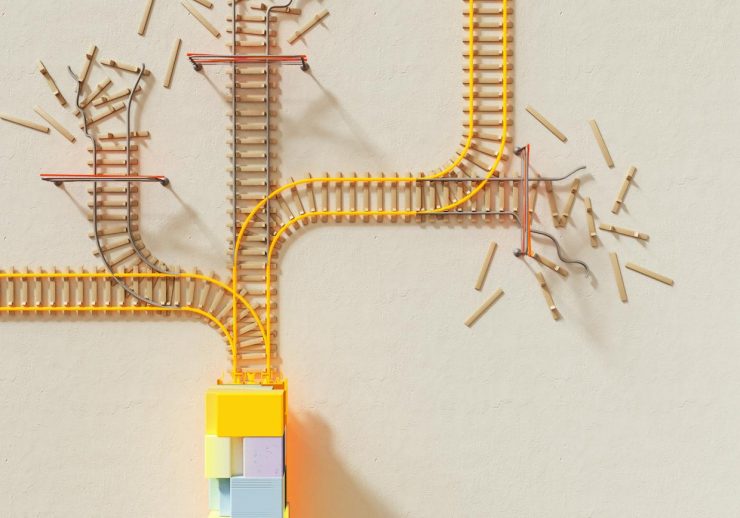 Creative illustration of train tracks on wooden blocks, depicting decision making concepts.